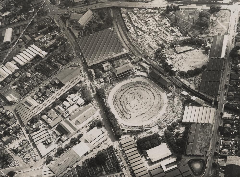 Aerial archival photograph of the Royal Brisbane Showground during the Ekka, with the crowded show ring visible, circa 1952.